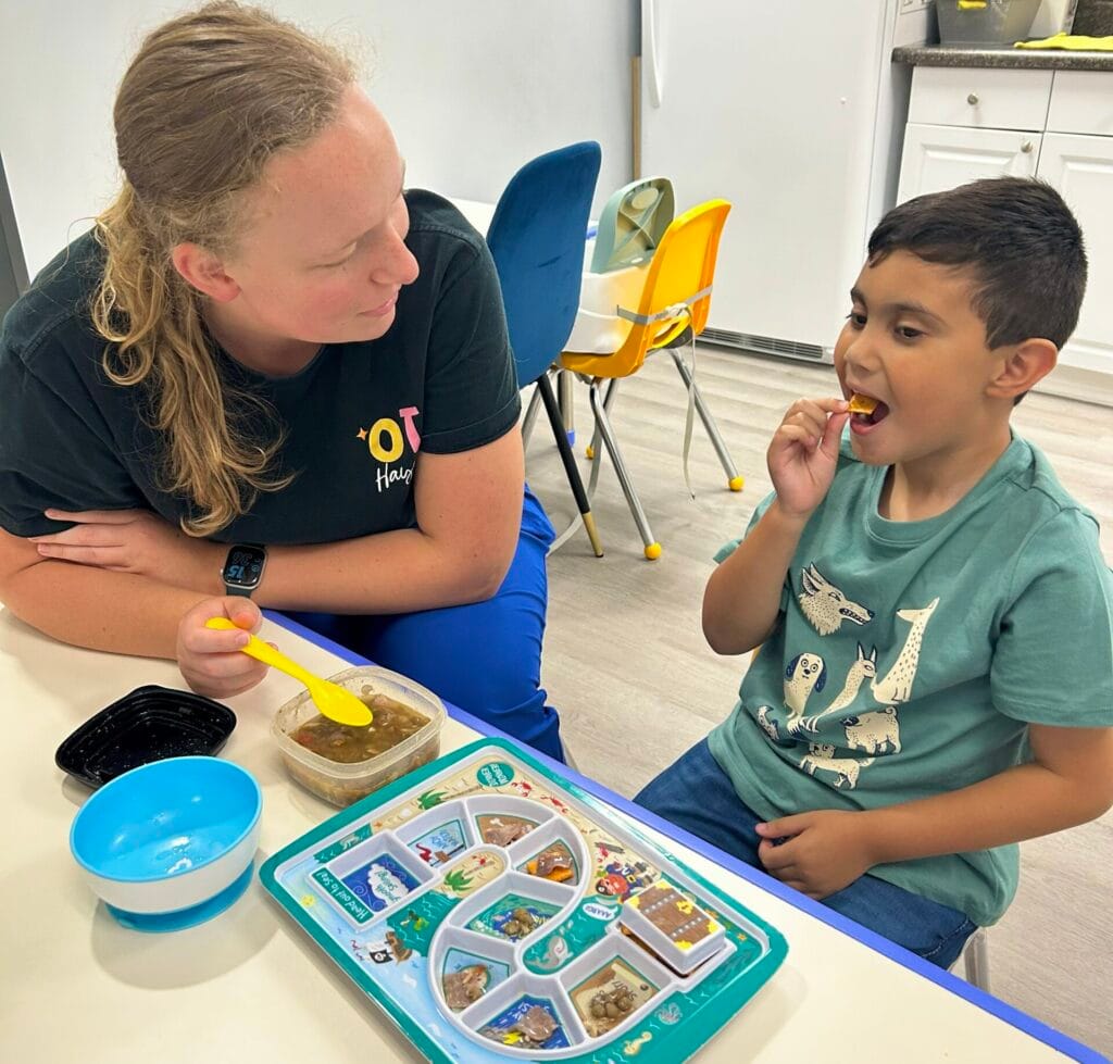 Child eating with therapist